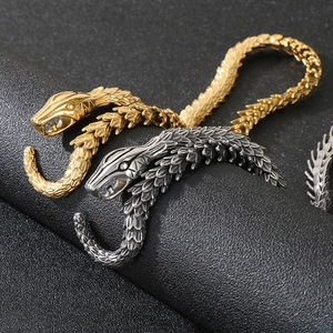Punk style snake pendant necklace in gold and vintage silver with detailed scale texture