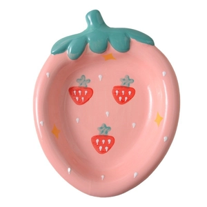 Cute pink strawberry ceramic dessert plate with star patterns on a clean white background