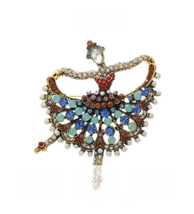 Close-up of vintage ballet dancer brooch with colorful rhinestones and pearls details