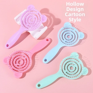Detail view of macaron-colored vented hair brushes with cute bear ear handles and round teeth