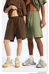 Detail of vintage washed pure cotton sweat shorts in coffee brown and olive green colors