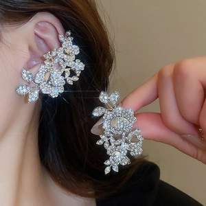 Detailed macro view of silver flower ear cuff featuring sparkling crystal embellishments