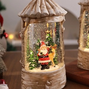 Macro view of Christmas crystal ball with Santa and snowman in cream white base