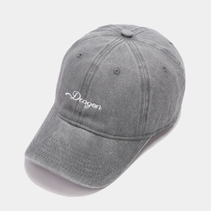 Detailed close-up of charcoal grey cotton baseball cap with white Dragon embroidery