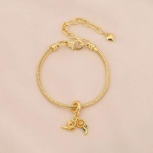 Close-up of gold sunflower and watering can charms on an adjustable link bracelet