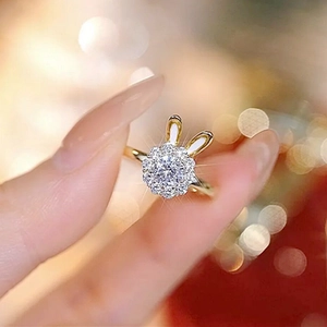 Close-up of golden bunny ear ring featuring crystal flower cluster on hand