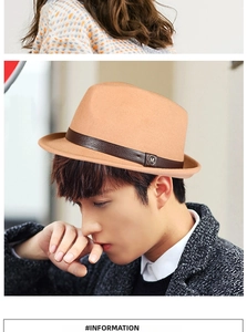 Detail of wool fedora hat featuring a brown leather band and metallic M logo emblem