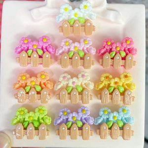 Detailed view of ten colorful resin flower fence charms for DIY crafts and accessories