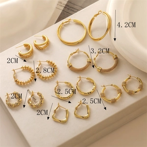 Macro view of gold-plated C-shaped earrings in various sizes from 2cm up to 4.2cm