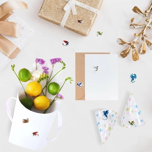 Macro shot of colorful dragon stickers on gift packaging with floral and marble background