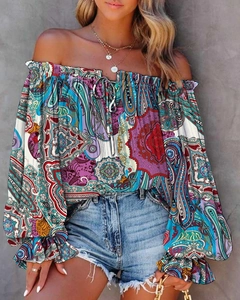 Close-up of bohemian paisley off-shoulder blouse with bell sleeves and drawstring detail