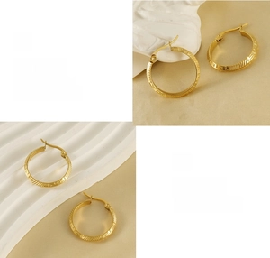 Close-up of 18K gold-plated stainless steel hoop earrings with Greek key pattern detail