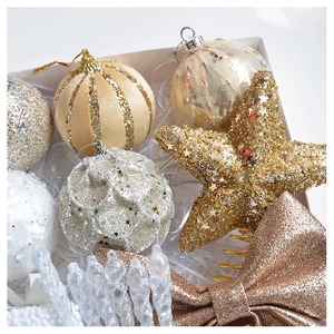 Detail of Christmas ornament gift set featuring gold and champagne velvet balls and bows