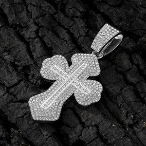 Iced out silver hip hop cross pendant necklace with rhinestones on black wood texture