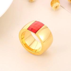 Detailed view of wide gold titanium ring featuring a red square-cut zircon stone