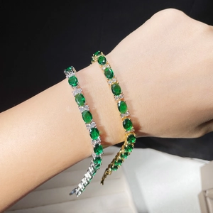 Gold and silver tennis bracelets with oval emerald green stones and AAA cubic zirconia