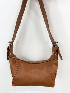 Nahaufnahme der braunen Ledertasche mit silbernen Beschlägen und Reißverschlussdetails