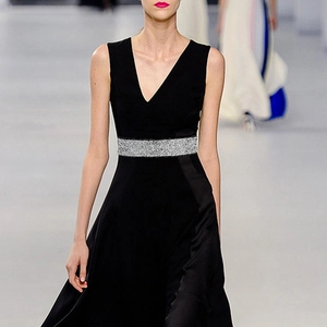 Detail view of sparkly silver rhinestone elastic wide belt on a black V-neck formal dress