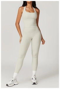Detail view of light grey women's yoga set featuring cropped tank top and high-waisted leggings