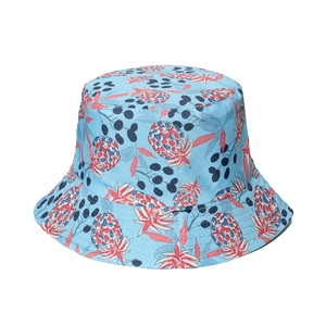 Reversible bucket hat with light blue fabric and vibrant red pineapple pattern for outdoors