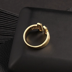 Detailed close-up of golden T-design open ring featuring pavé set cubic zirconia accents