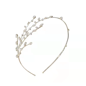 Elegant gold leaf headband with sparkling rhinestones for bridal or formal hair styling