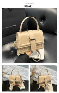 Detail of khaki square crossbody bag with metallic buckle and adjustable strap