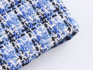 Gros plan sur la texture du tissu en tweed bleu et blanc avec motifs de tissage