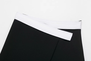 Detailed view of black and white contrast high-waist band with precise stitching on skort
