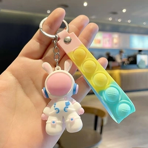 Detail of cute pink space rabbit astronaut keychain with colorful gradient silicone strap