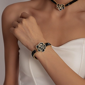 Detail of dark rose choker and bracelet with black beads, gold edges and crystal rhinestones