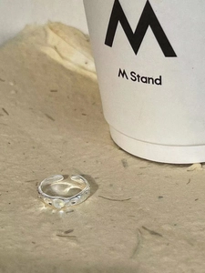 S925 sterling silver moonstone ring with irregular texture next to coffee cup