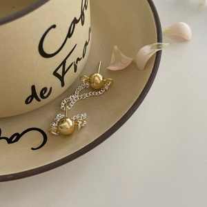 Minimalist S925 sterling silver chain drop earrings with golden ball on ceramic dish