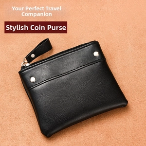 Detail showing black lychee grain leather coin purse with zipper and metal rivets