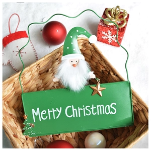 Detail of iron Merry Christmas hanging sign with Santa Claus figurine and festive ornaments