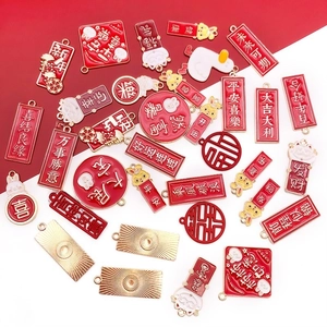 Macro detail of red and gold Chinese New Year enamel charms with festive blessings