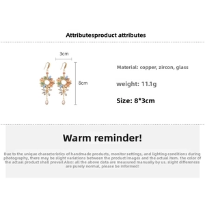Detail of bohemian drop earrings with orange and blue zircon, copper, 8x3cm size