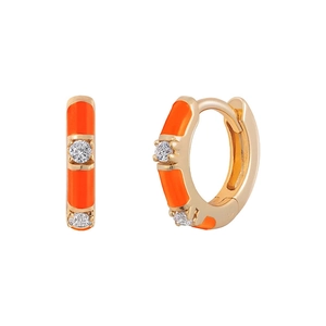 Close-up of golden bamboo hoop earrings with bright orange enamel and clear zircon stones
