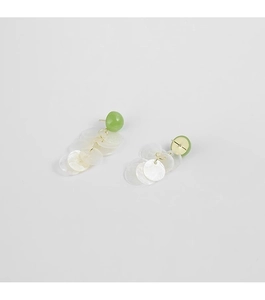 Detailed shot of green dome earrings with white circular cascading shell tassel pendants