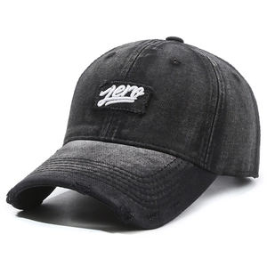 Distressed dark grey denim baseball cap with white Zero embroidery and ripped brim detail
