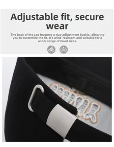 Detail of adjustable silver metal buckle on the back of a black cotton baseball cap