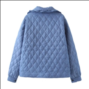 Women's blue diamond quilted jacket featuring a relaxed fit and waist tie back view