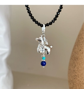 Detail of Scottish Terrier pendant with turquoise beads on black beaded necklace chain