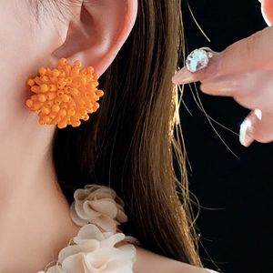 Vibrant orange beaded firework stud earrings in handmade 3D floral design for women