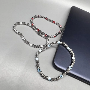 Detailed shot of three elastic 18K gold plated beaded bracelets with colorful evil eye beads