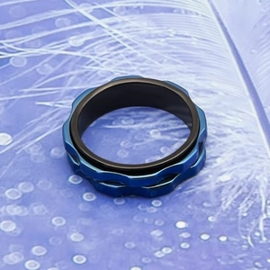 Detailed macro shot of blue and black spinning gear ring with textured grooves