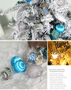 Detail of flocked PE Christmas tree with mini ornaments and solid wood base