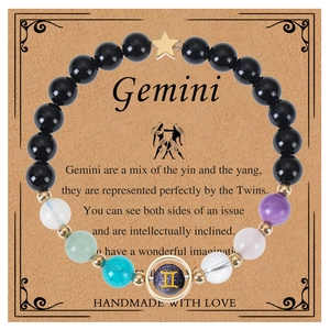Detailed view of Gemini constellation bracelet with mixed natural beads on a display card