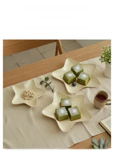 Close-up of cream star-shaped dessert plates on a linen cloth for table decor