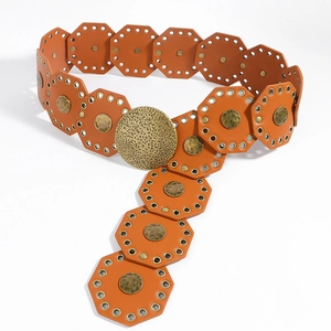 Close-up of vintage wide belt featuring orange octagonal panels and a hammered round buckle